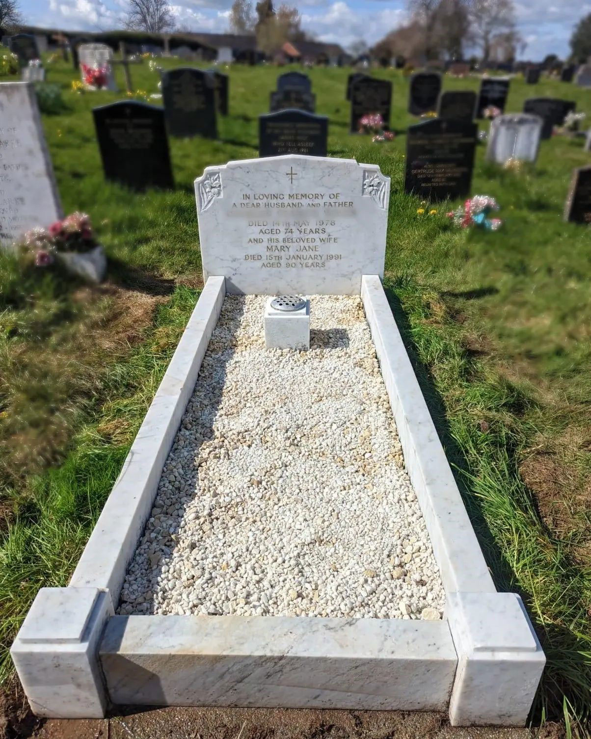 Image of stonemason working on lettering or carving.